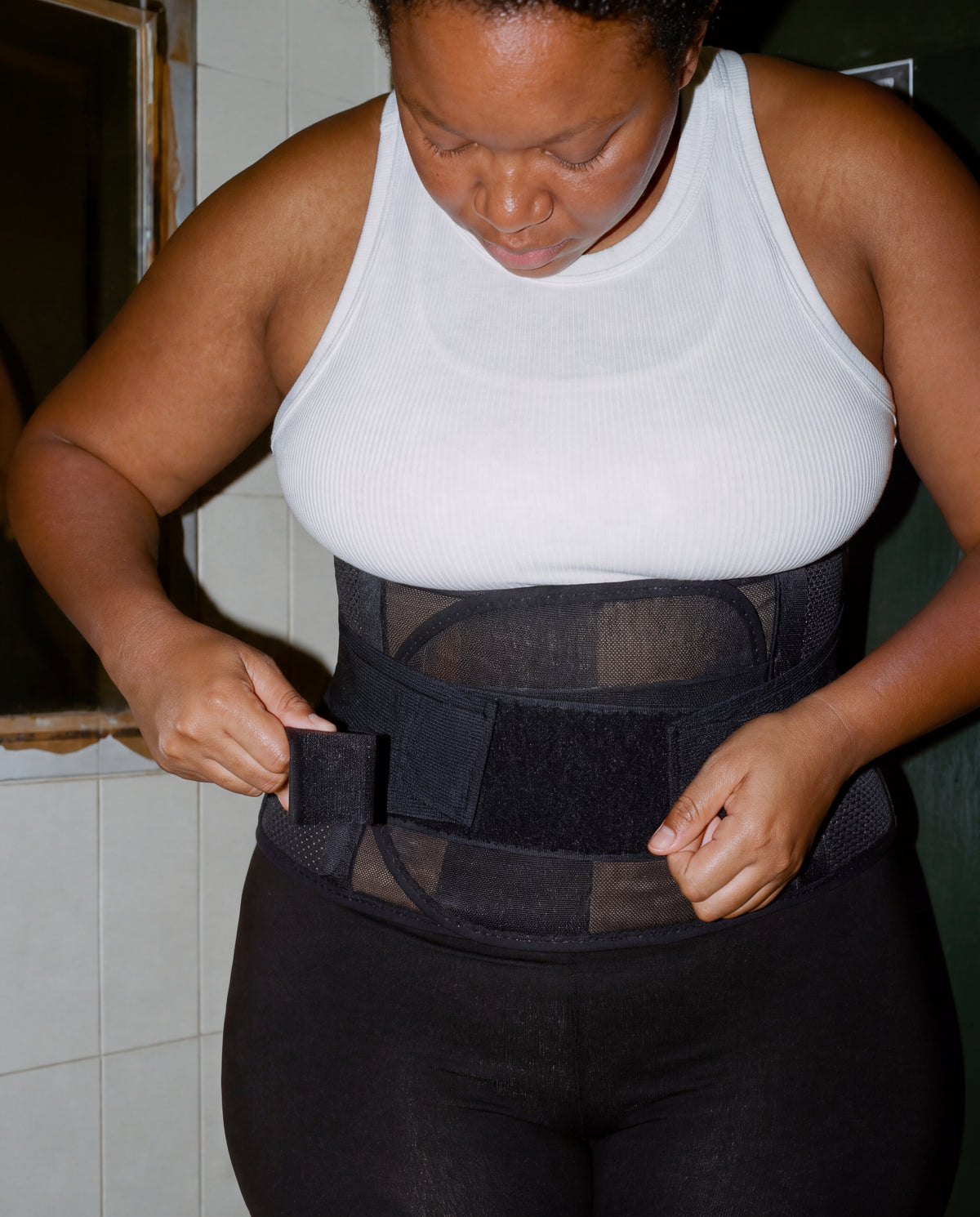 Woman wearing the nude Grace Tummy Band at home